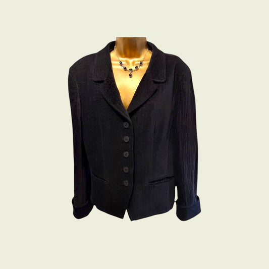 Black blazer on a mannequin with a plain background