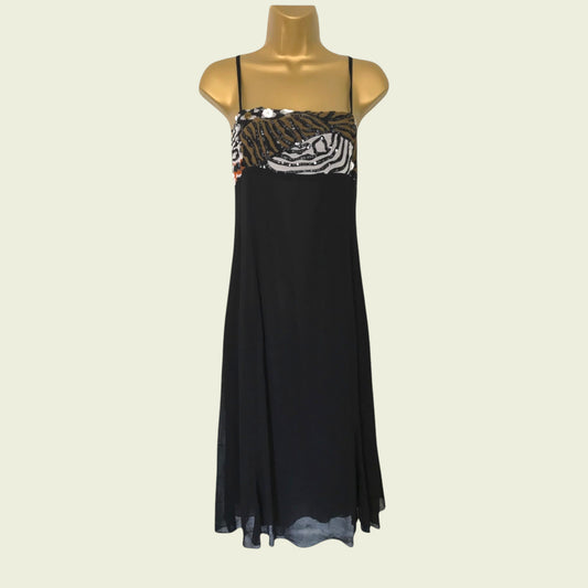 Black dress with zebra print top on a mannequin against a beige background
