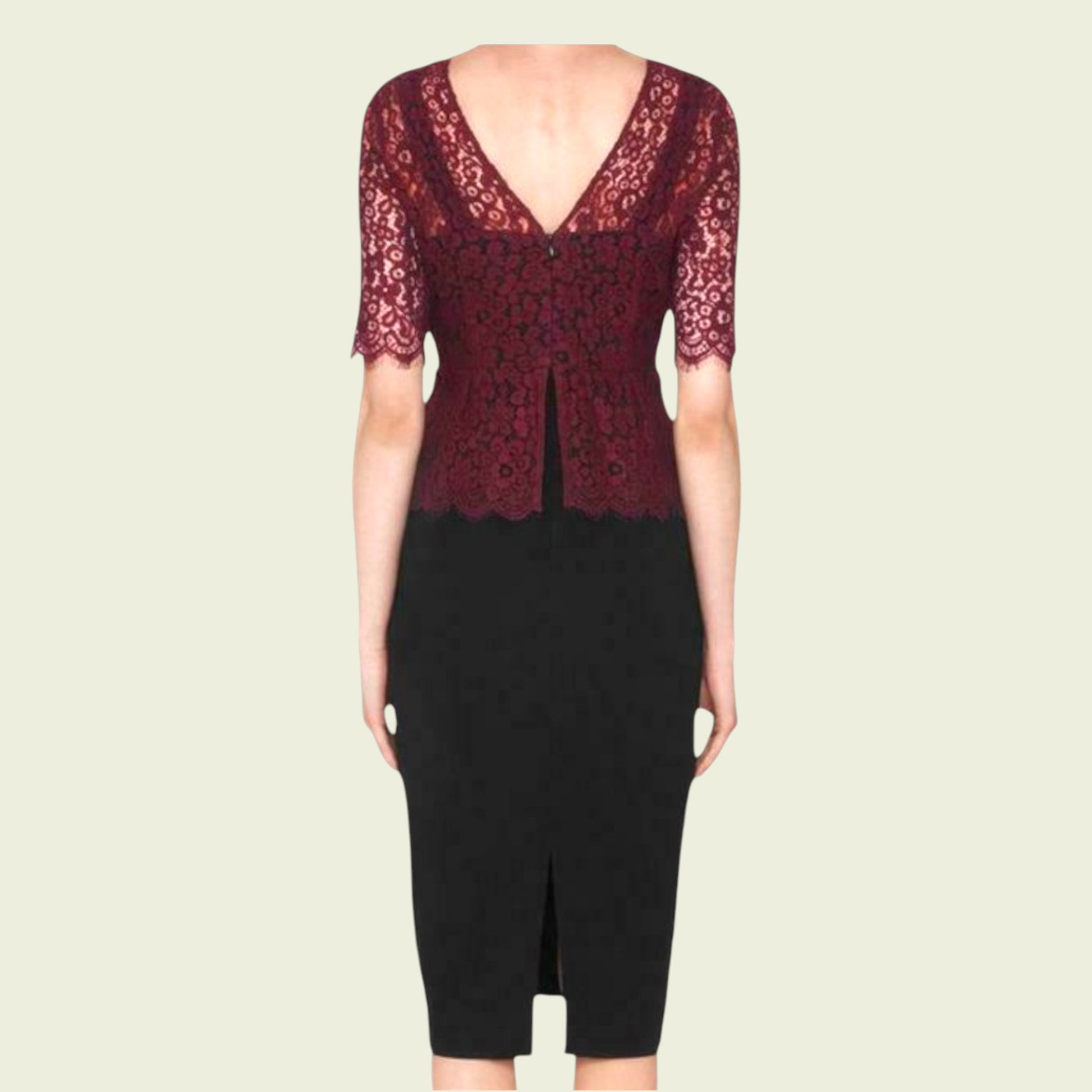 Black dress with red lace detailing on a beige background