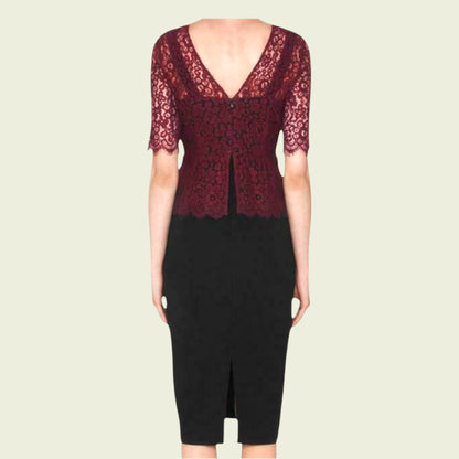 Black dress with red lace detailing on a beige background