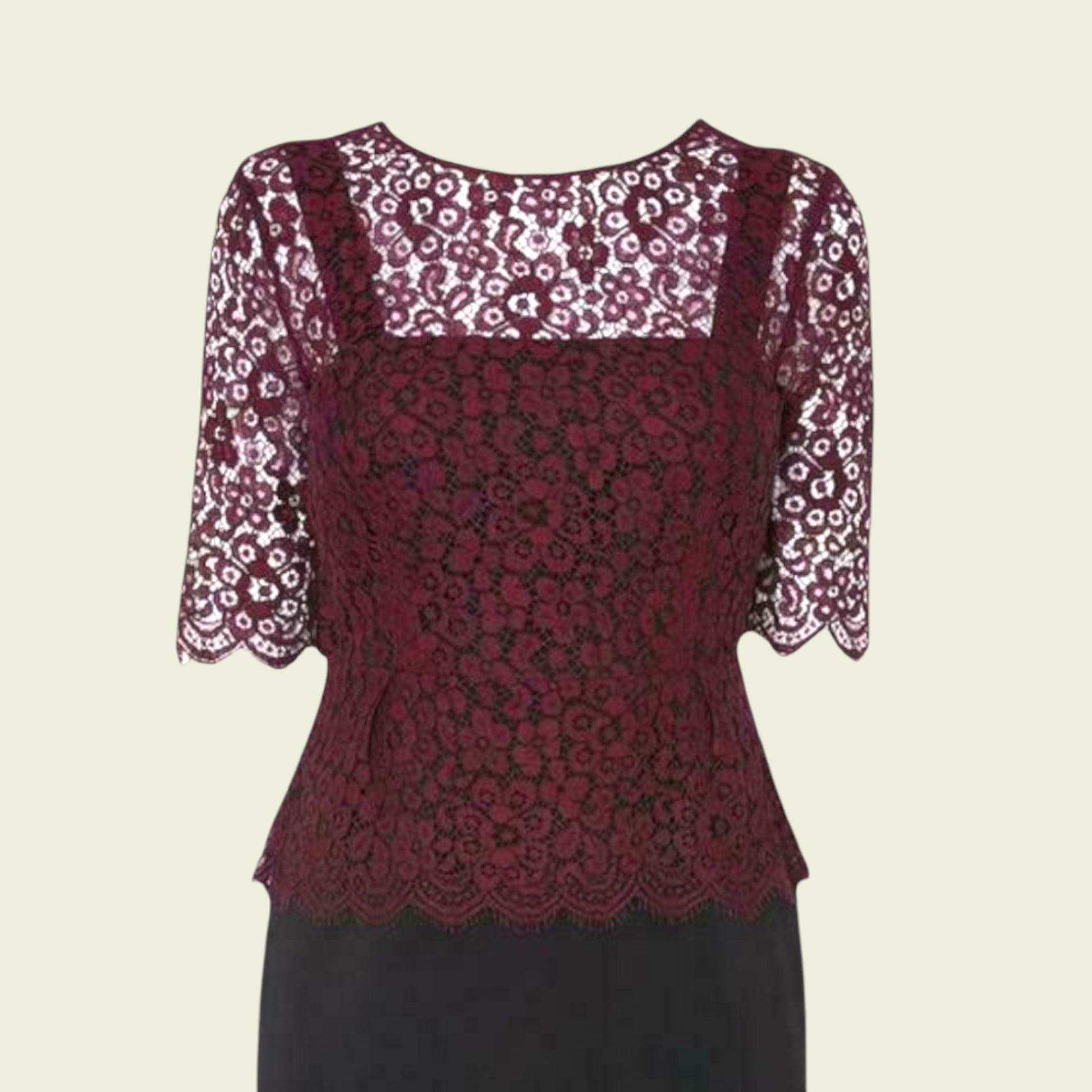 Red lace top with floral sleeves on a beige background