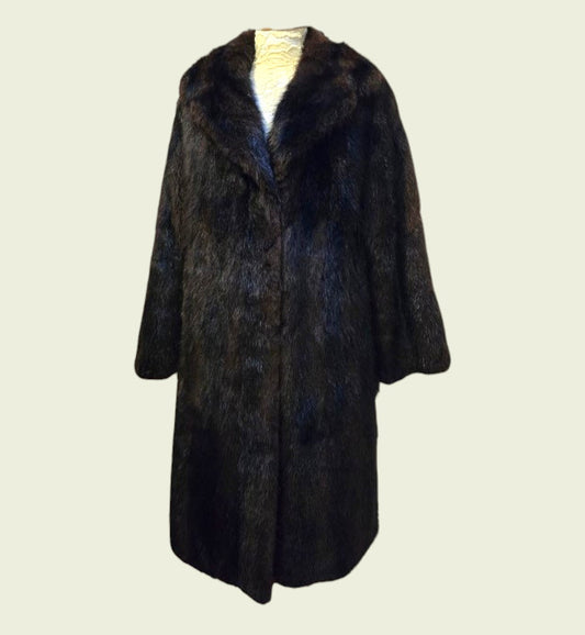 Dark fur coat on a light beige background
