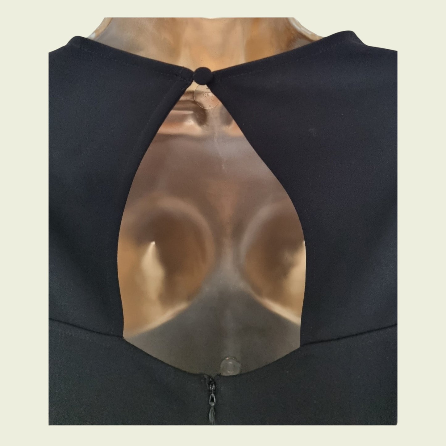 Navy garment with a cut-out design on a beige background