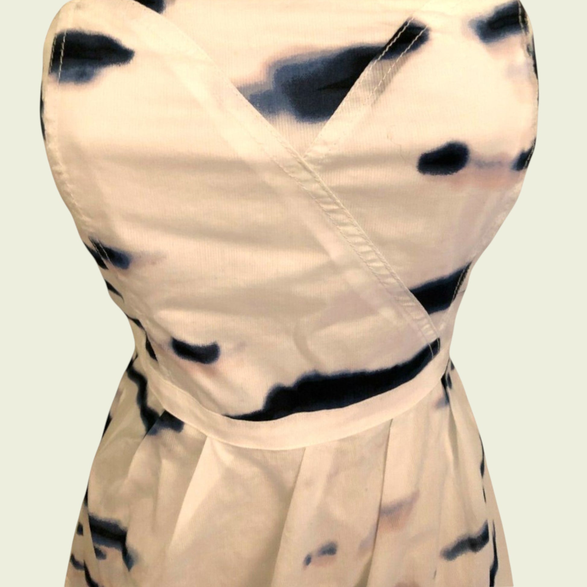 Beige dress with black tie-dye pattern on a light background