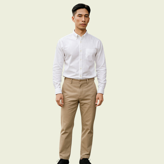 Man wearing a white dress shirt and beige pants on a light beige background