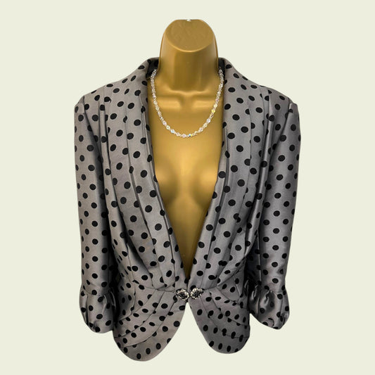 grey polka dot jacket on beige background