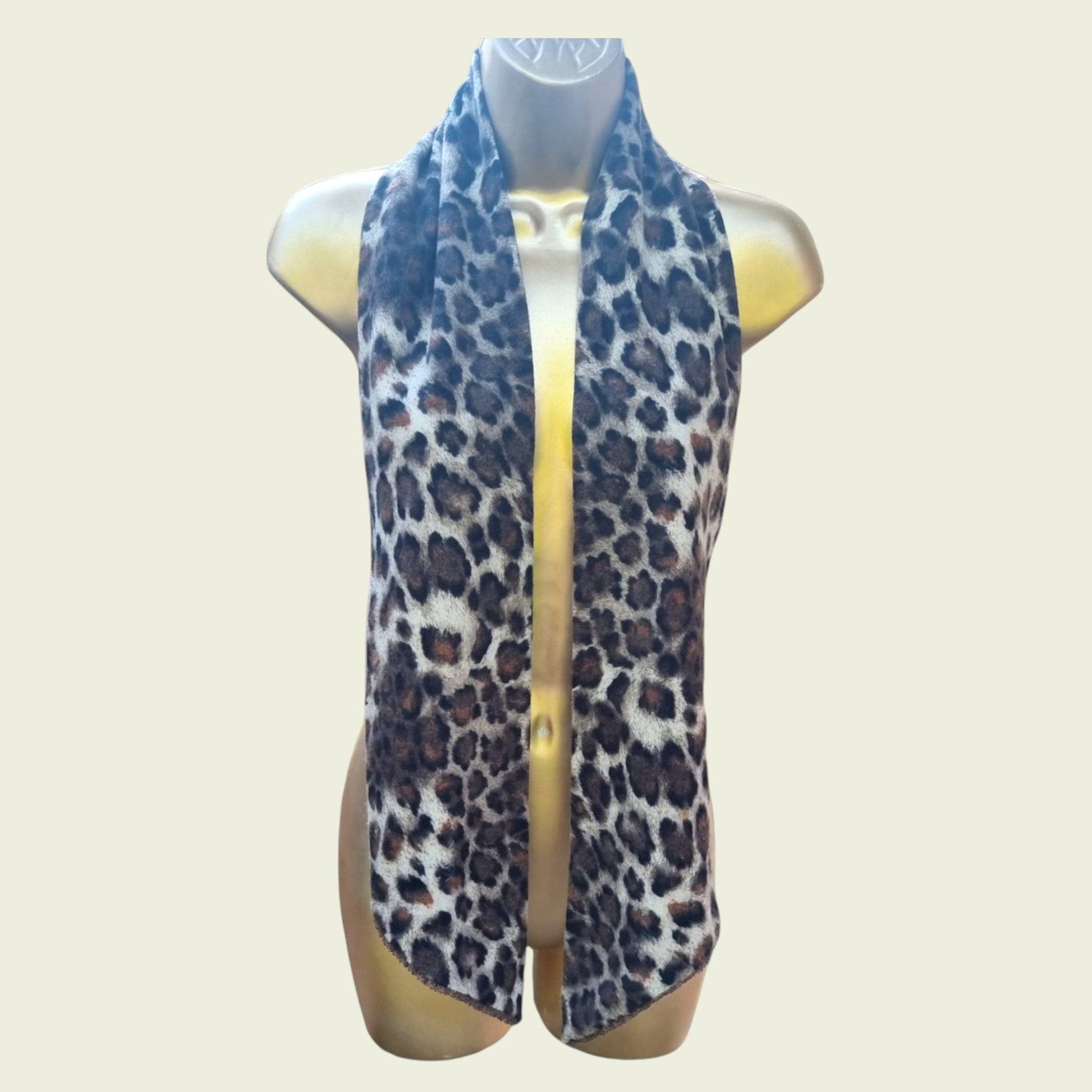 Leopard print scarf on a mannequin with a plain background