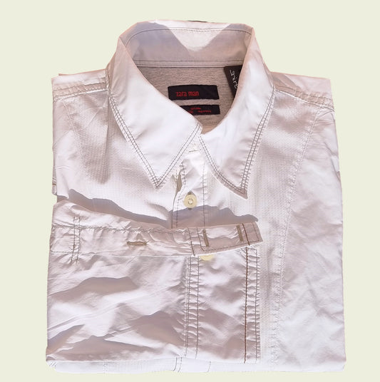 Men's white pleated dress shirt on beige background
