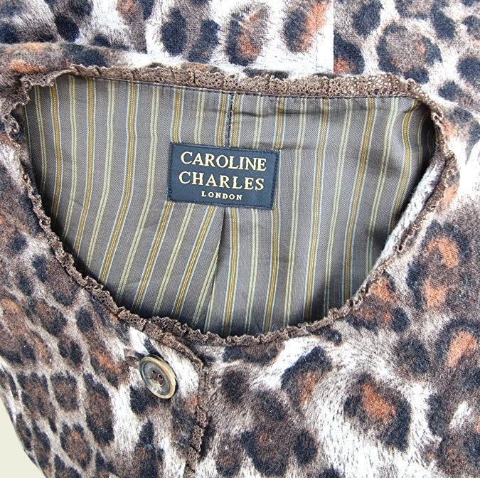 Caroline Charles label inside a leopard print garment with a striped lining.