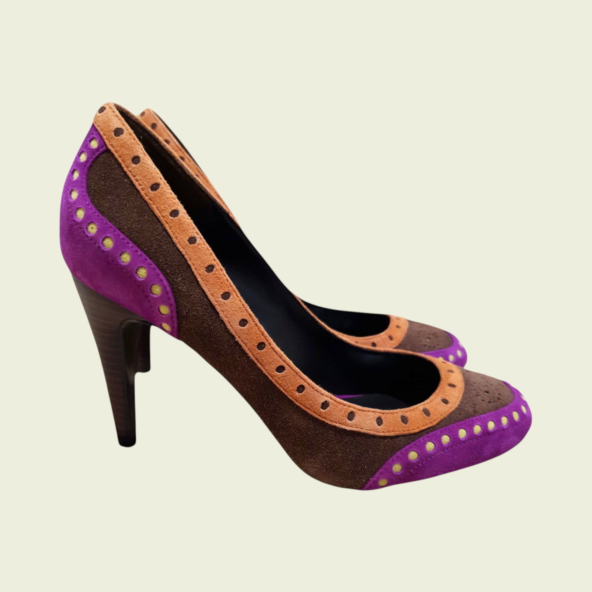 High-heeled shoe with purple and brown design on a beige background
