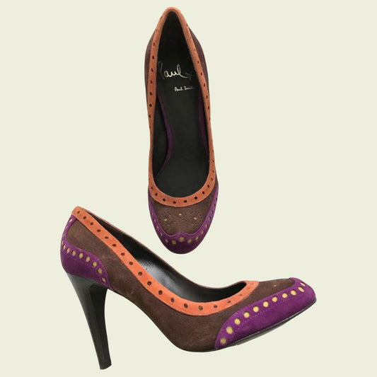 Pair of high-heeled shoes with purple and orange accents on a beige background