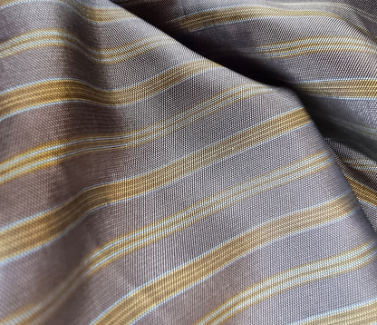 Close-up of striped fabric with brown, beige, and gray colors.