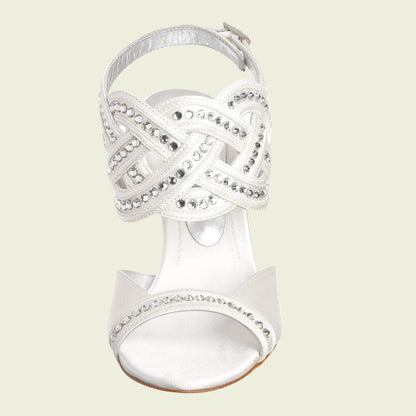 Silver high-heeled sandal with intricate design on a light beige background