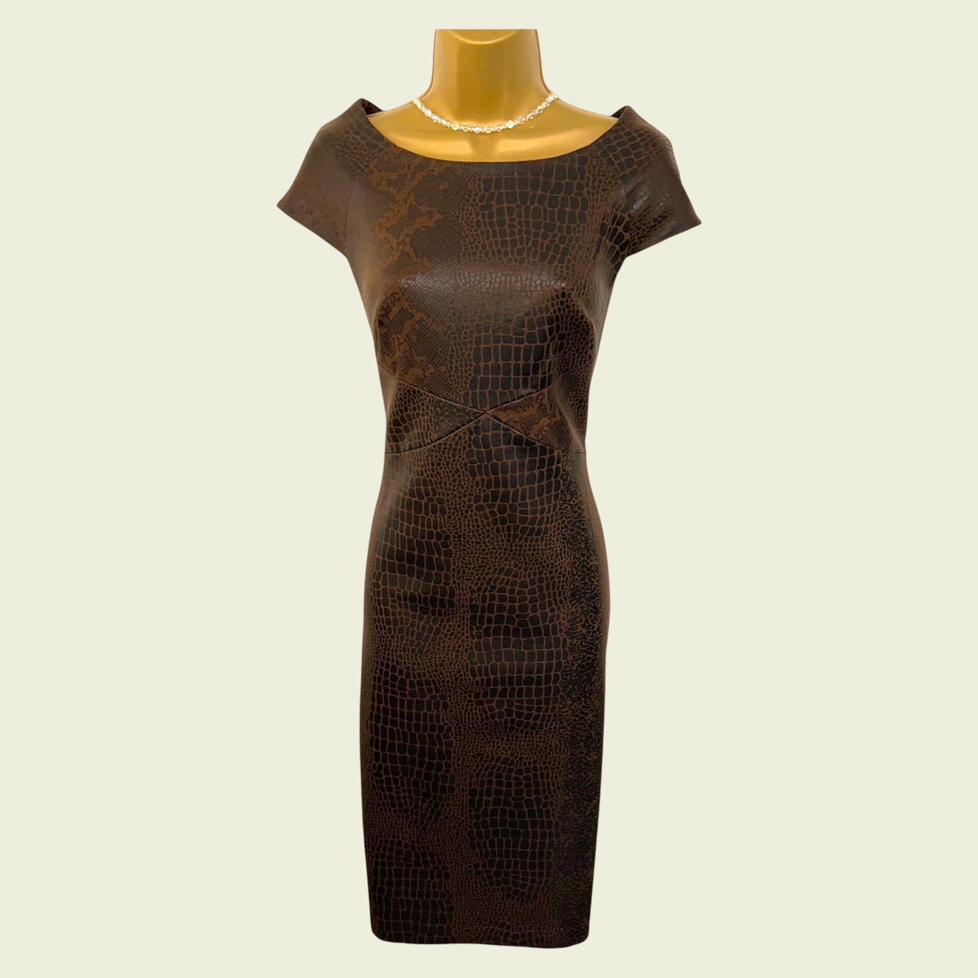 Brown textured dress on a mannequin against a beige background