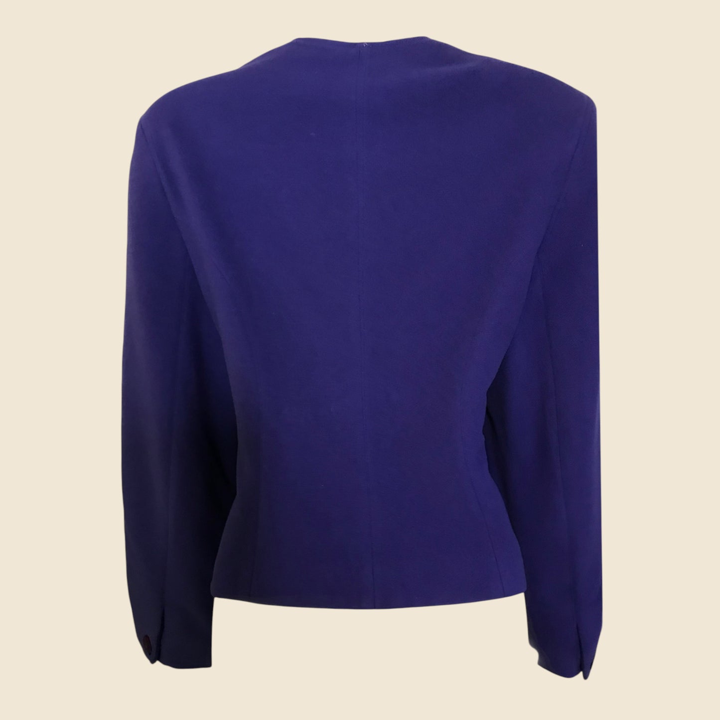 Purple jacket with long sleeves on a beige background