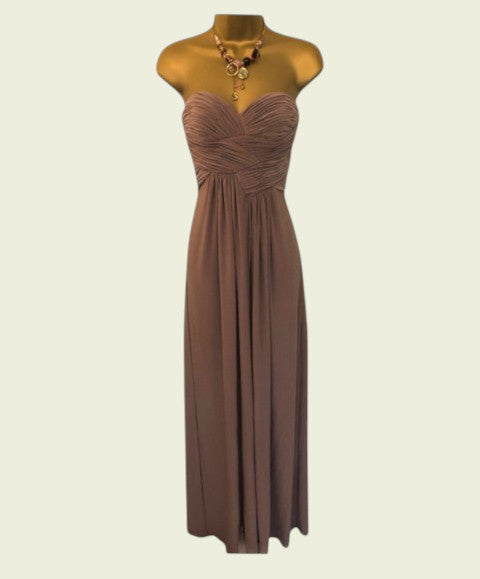 Brown evening gown on a mannequin against a white background