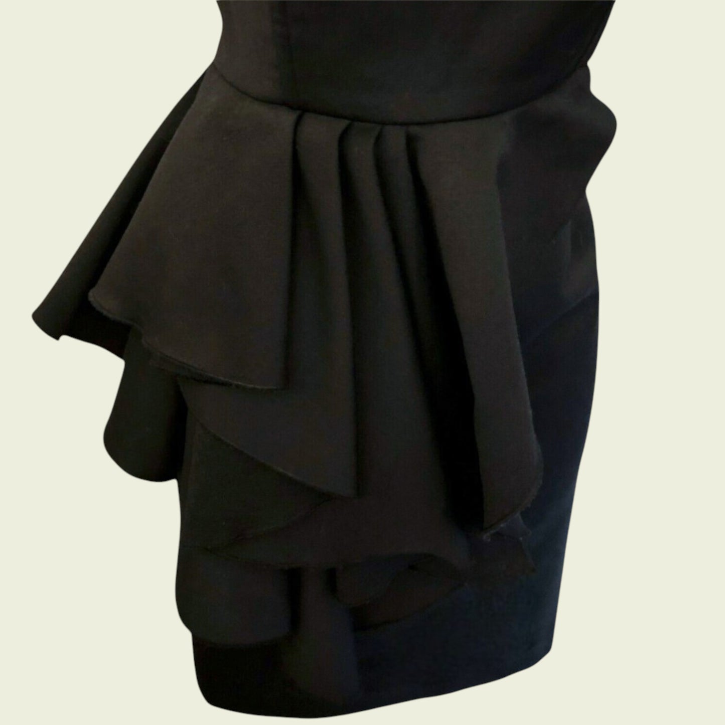 Black ruffled skirt on a beige background