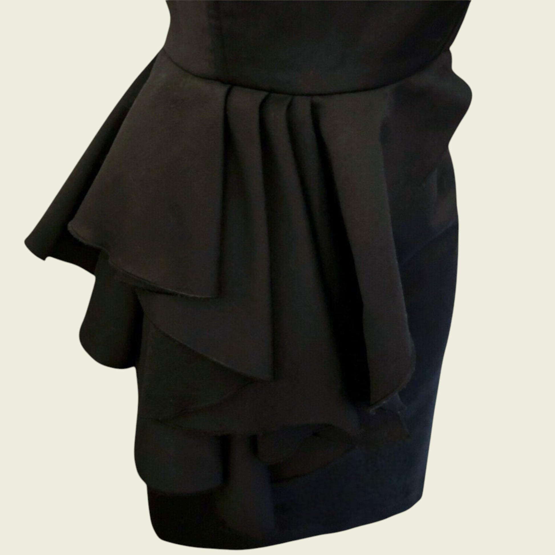 Black ruffled skirt on a beige background