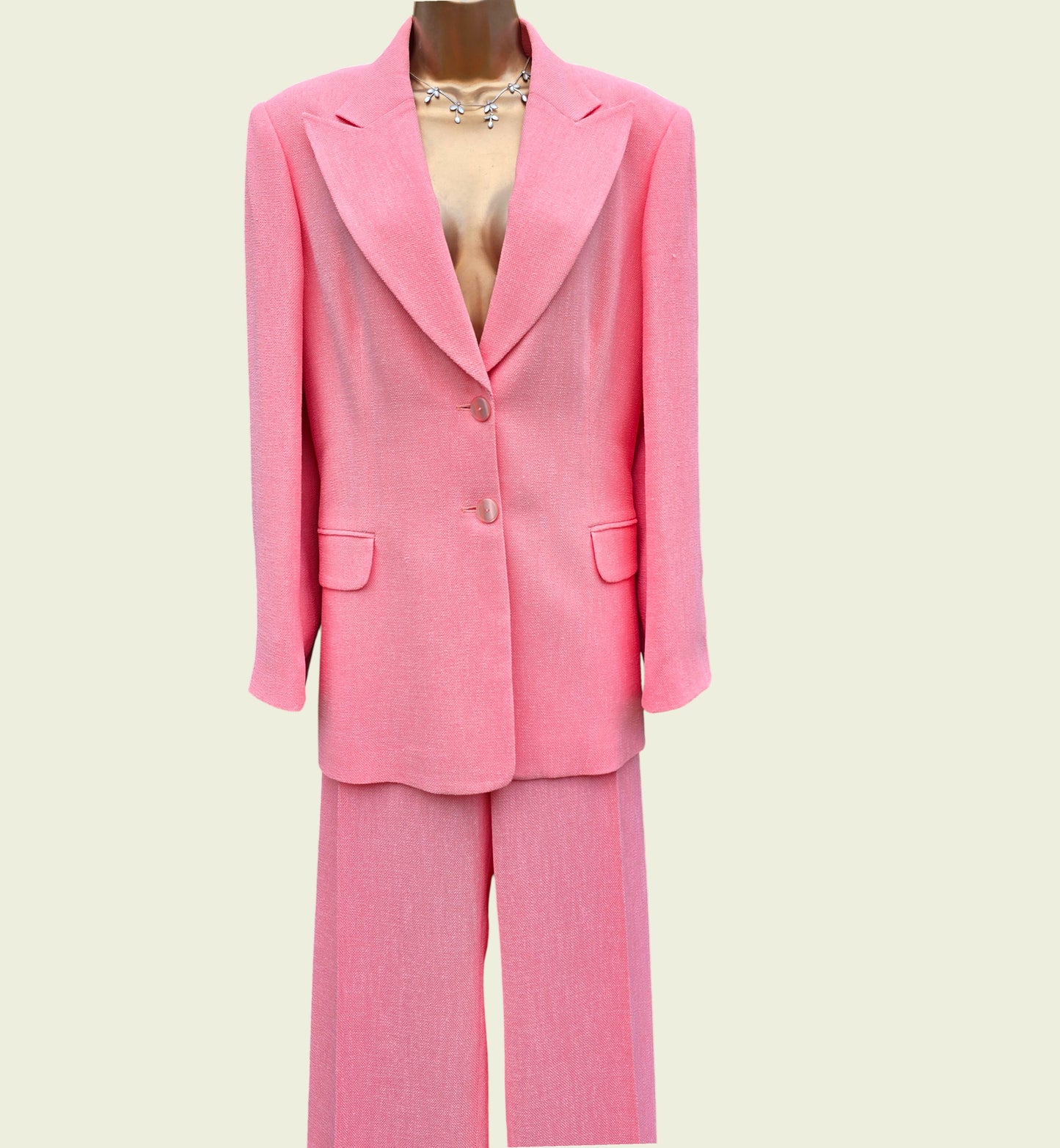 Pink suit on a mannequin against a light beige background