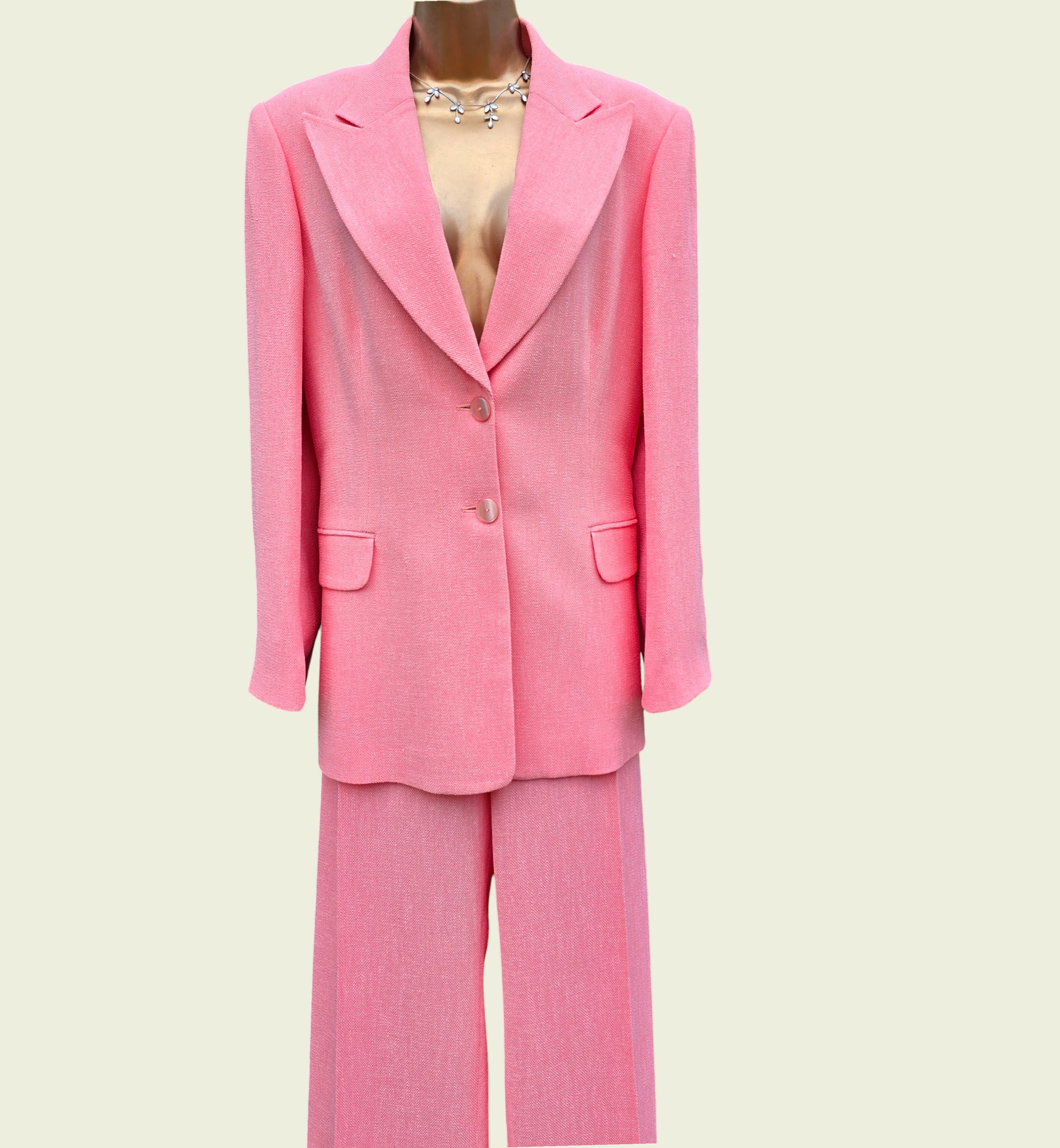 Pink suit on a mannequin against a light beige background