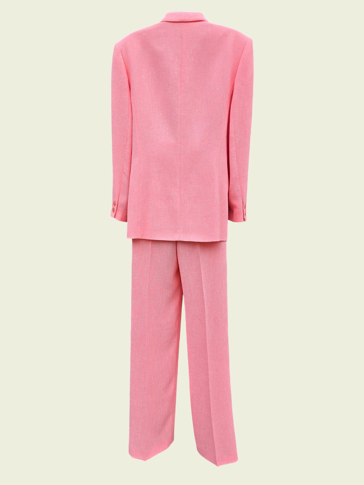 Pink suit jacket and pants on a light beige background