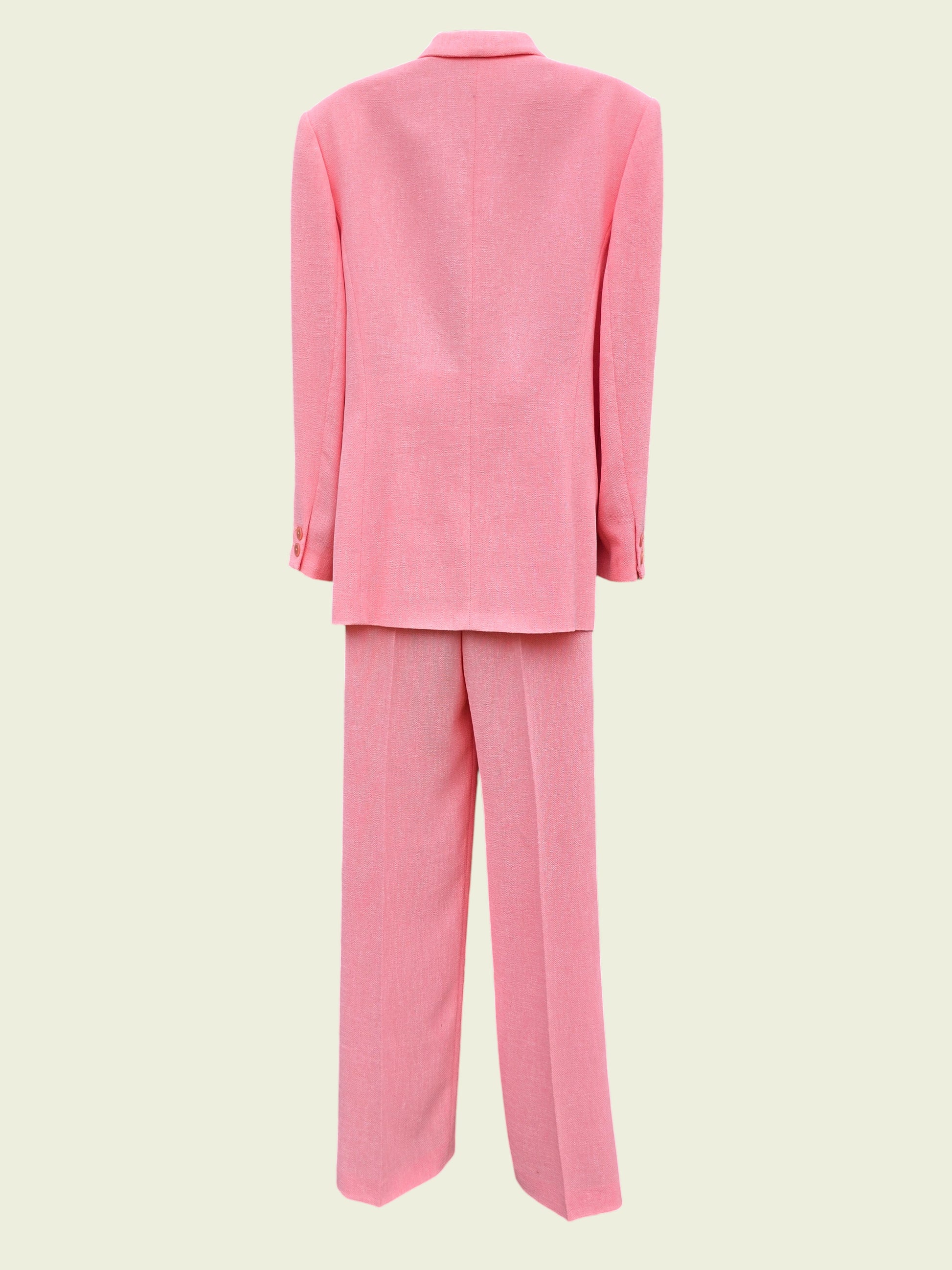 Pink suit jacket and pants on a light beige background