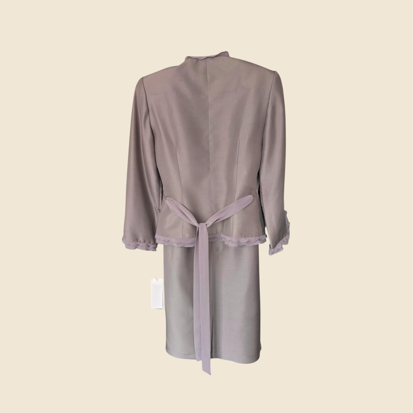 Light gray skirt and jacket with lace trim on a beige background