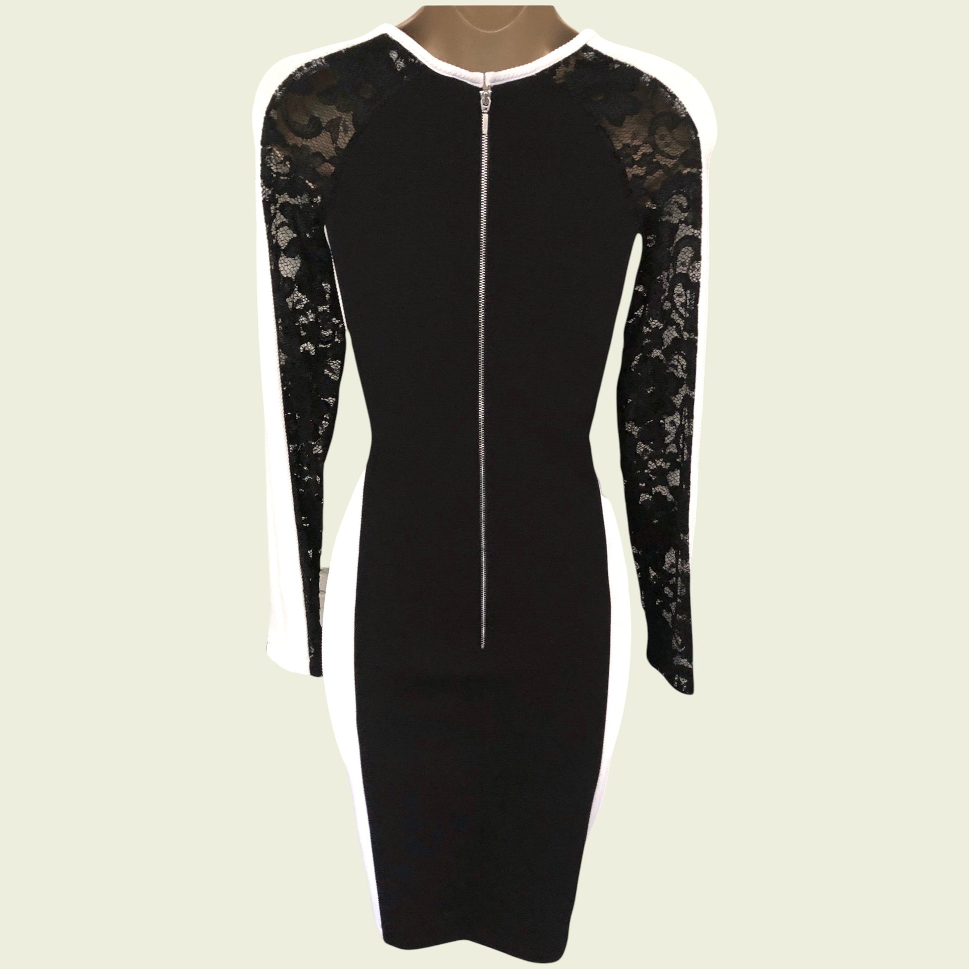 Black dress with lace sleeves on a beige background