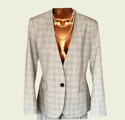 Mint green blazer with a pearl necklace on a beige background