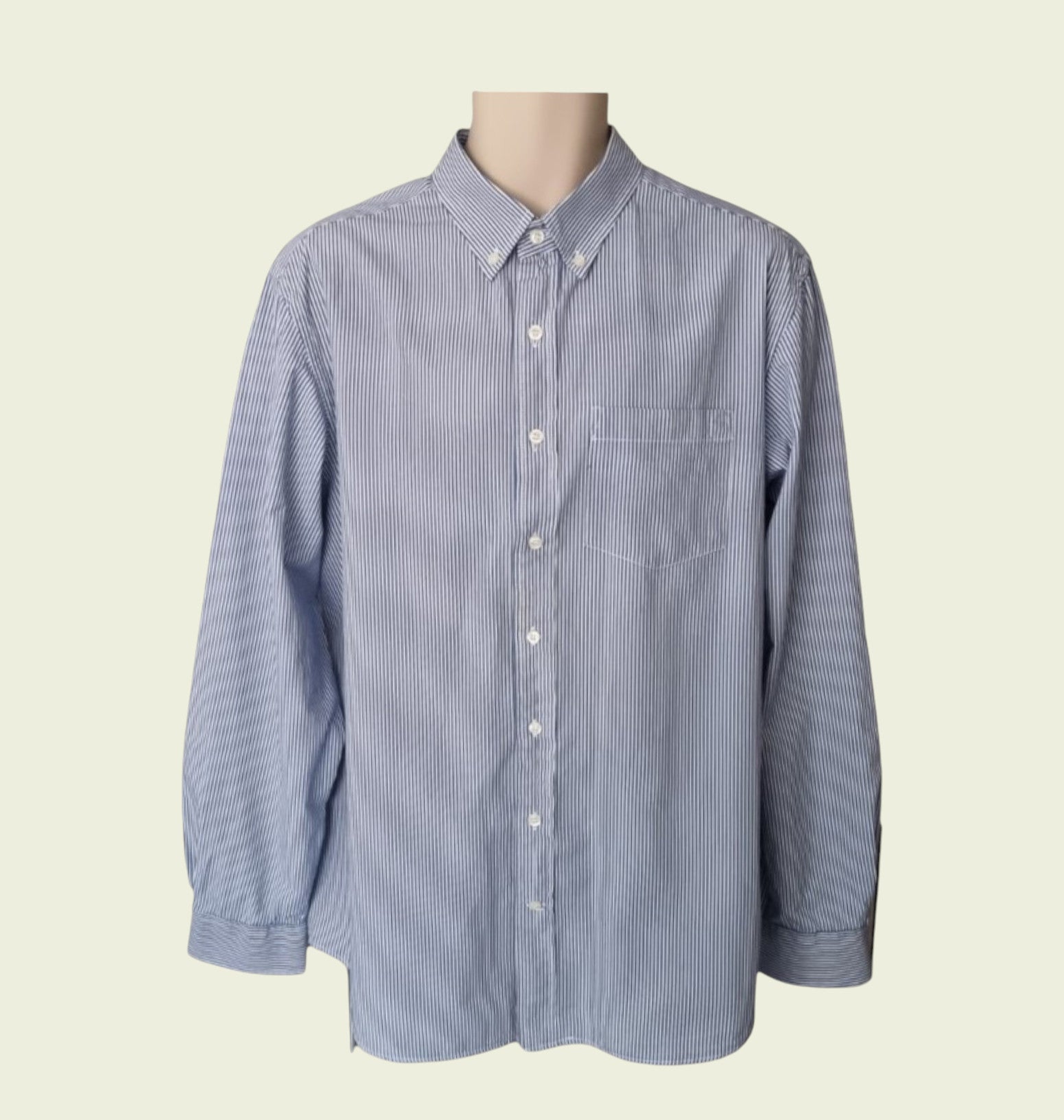Blue striped shirt on a mannequin against a beige background