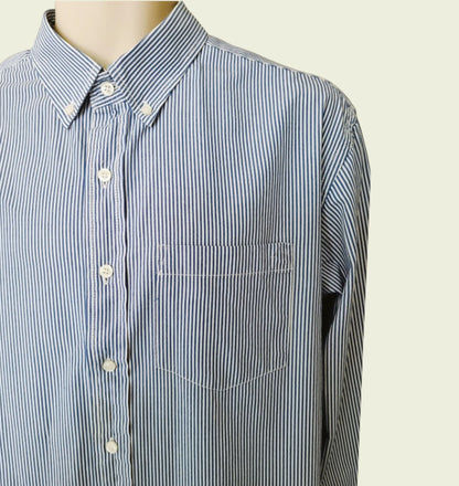 Blue and white striped shirt on a mannequin against a beige background