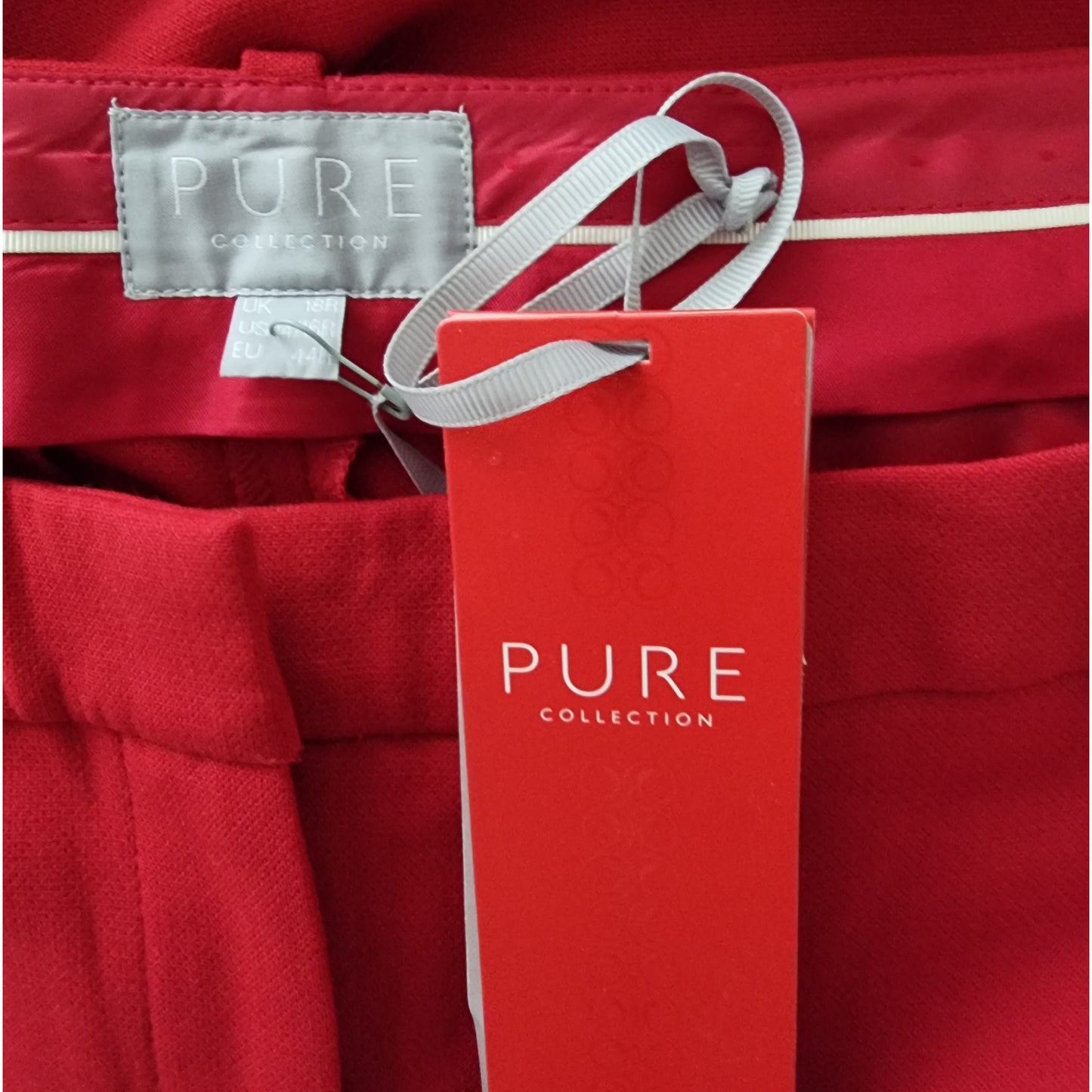 Red garment with 'PURE Collection' label and tag.