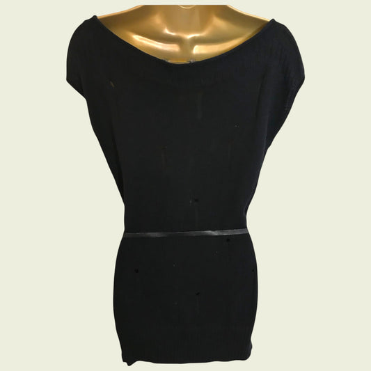Black top on a mannequin against a beige background