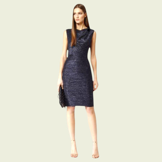 Woman wearing a dark blue dress on a light beige background