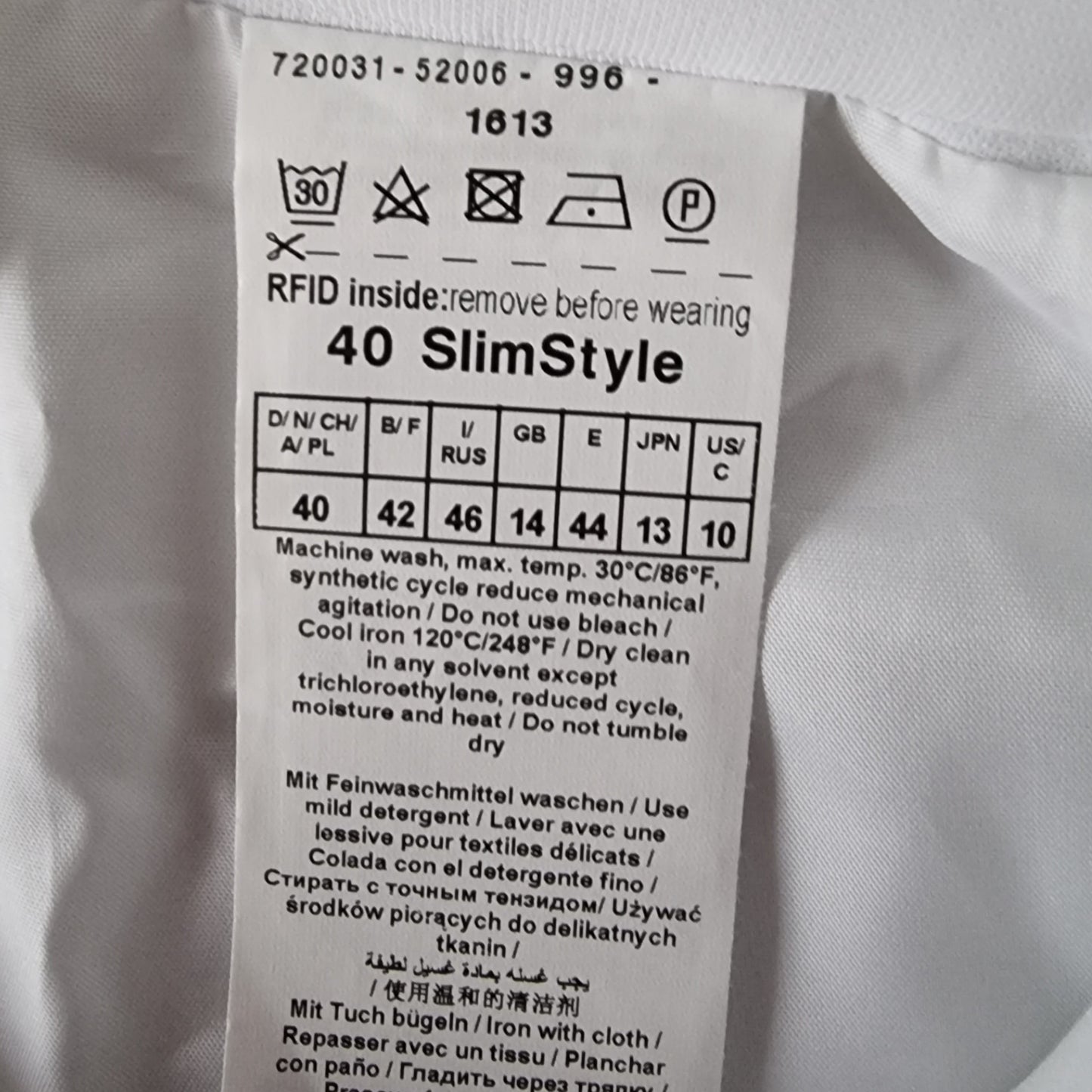 Clothing label with size chart and care instructions on a white garment.