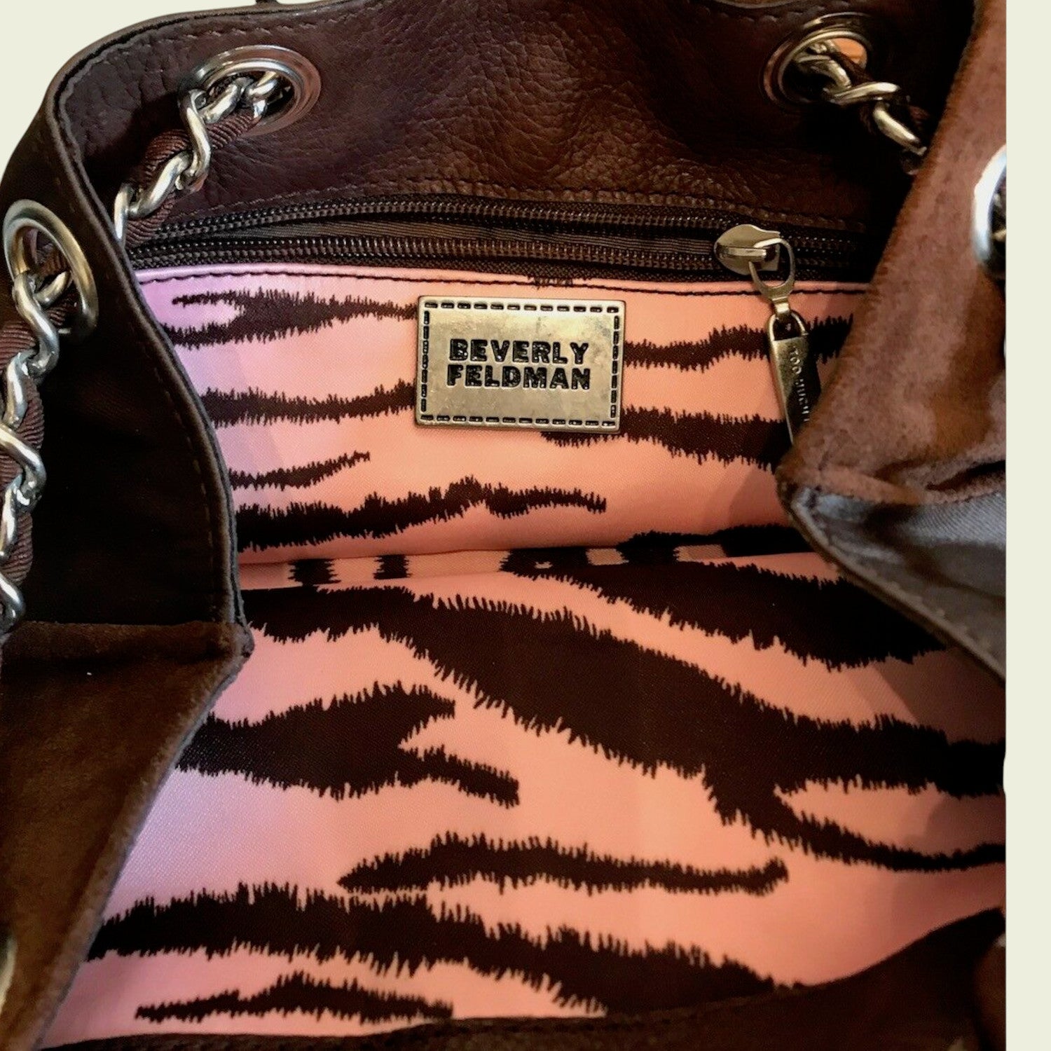 Brown handbag with tiger stripe pattern lining and Beverly Feldman label.