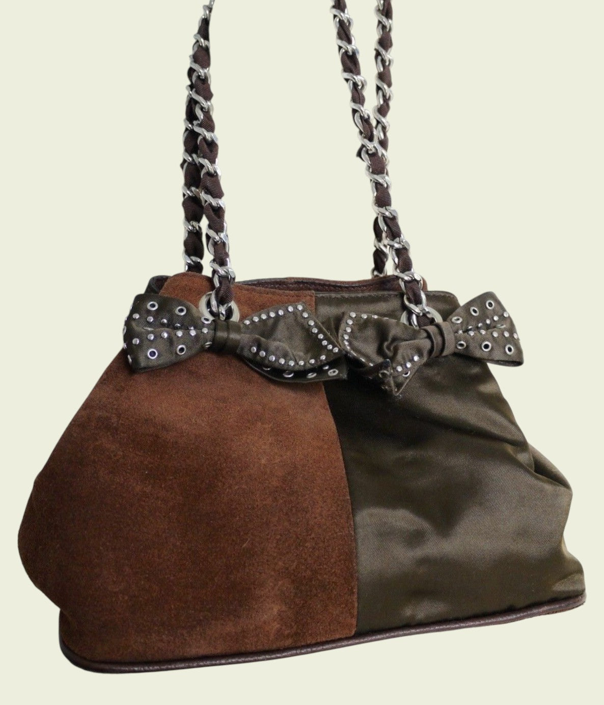 Two-toned handbag with a bow detail on a beige background
