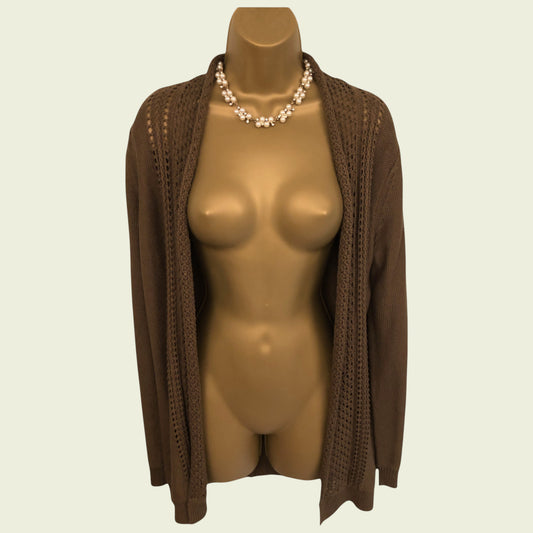 Mannequin wearing a brown cardigan on a beige background
