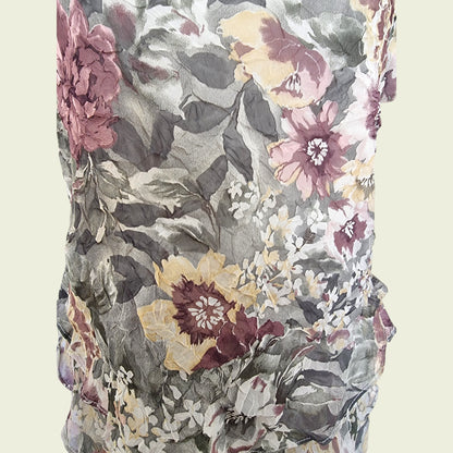 Floral patterned fabric with pink, yellow, and gray flowers on a beige background