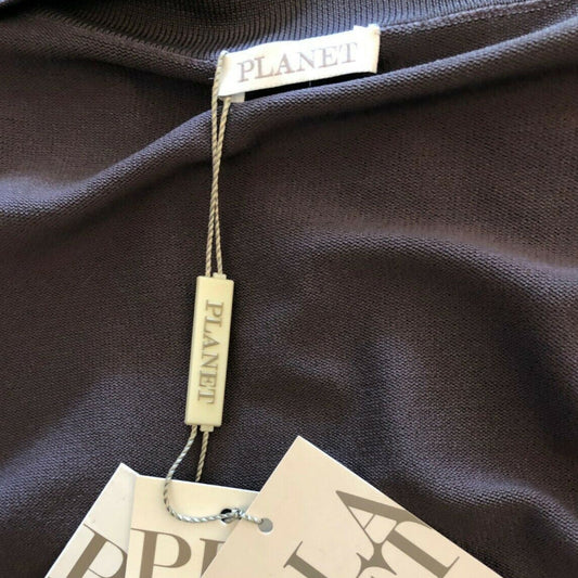 Close-up of a brown garment with 'PLANET' brand tags on a dark fabric background.