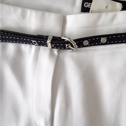 Close-up of a navy belt with silver buckle on a white shirt.