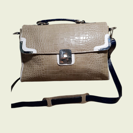 Beige crocodile-patterned handbag with a black strap on a light beige background
