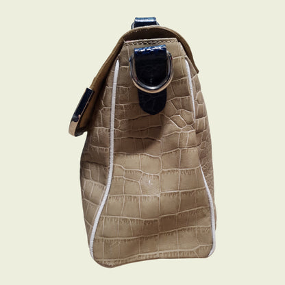 Brown textured bag with a strap on a beige background