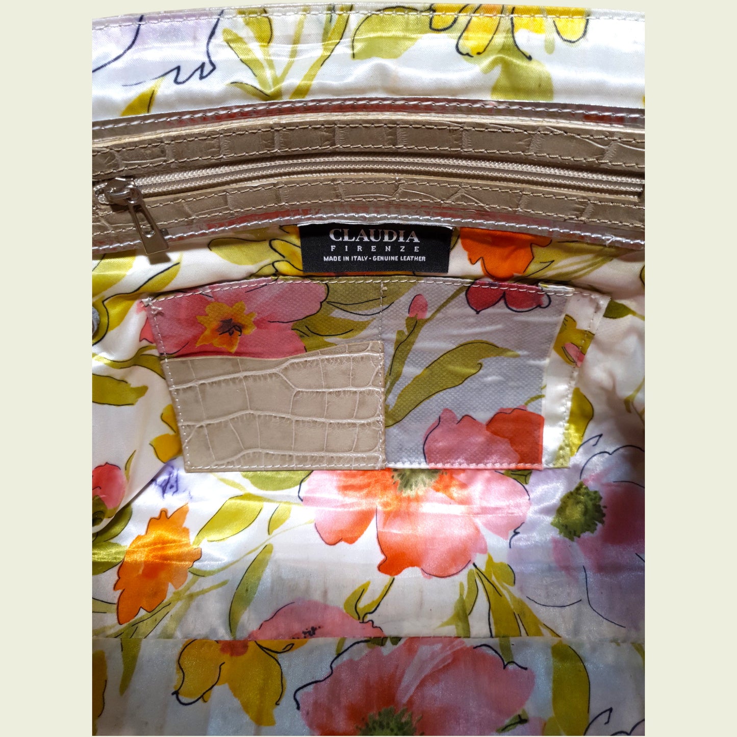Floral-pattern and 'CLAUDIA' label on inside of bag.