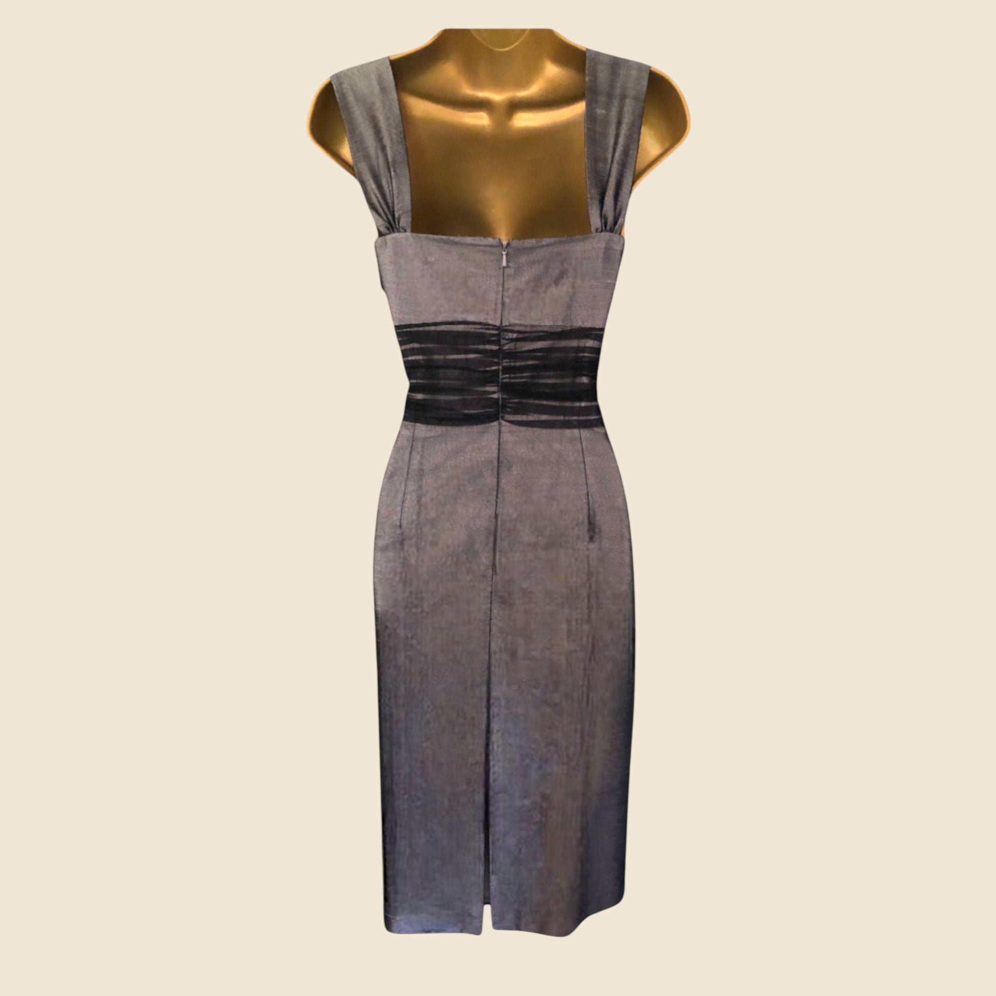 Gray dress on a mannequin against a beige background