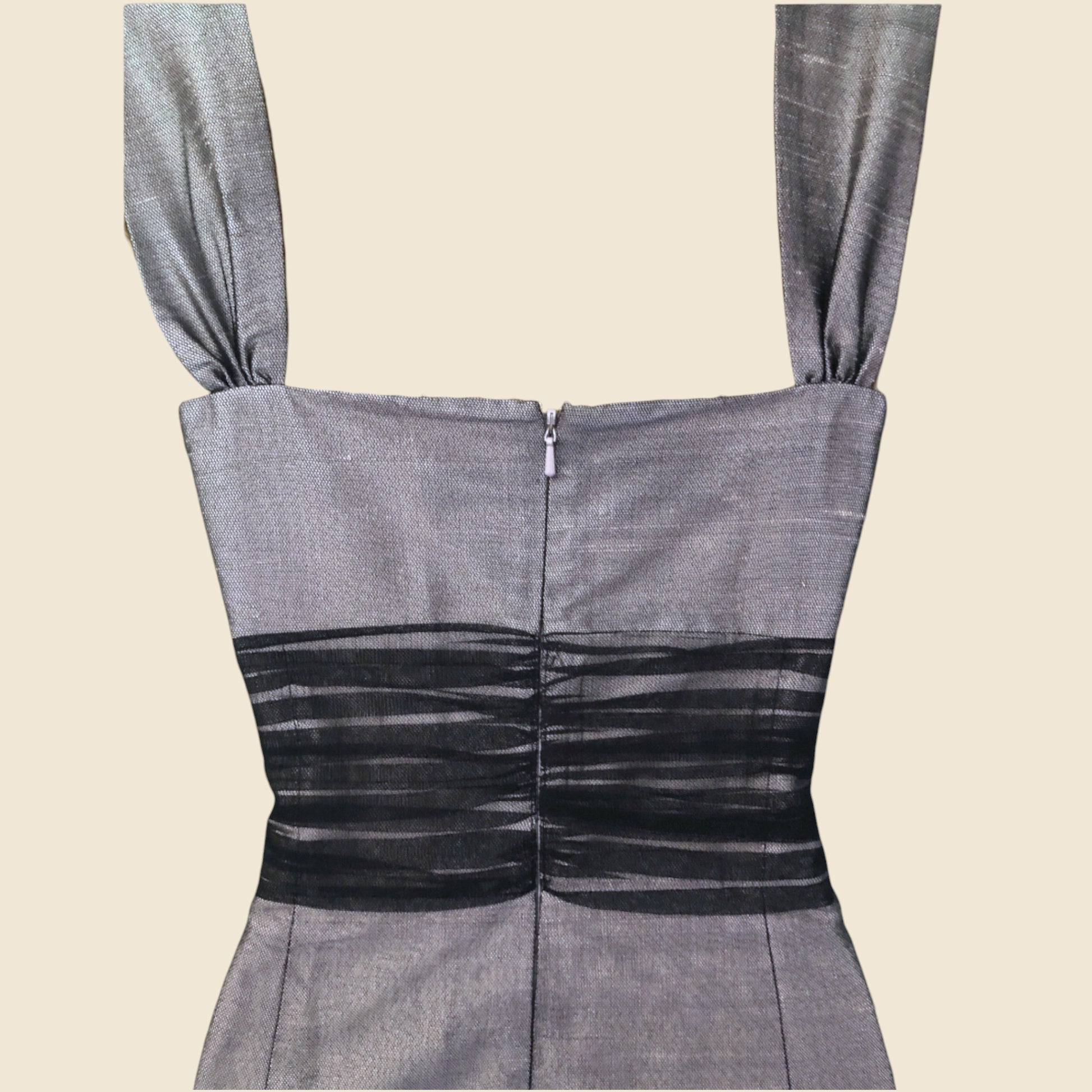 Gray dress with black detail on a beige background