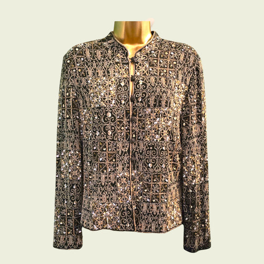 Elegant jacket with intricate patterns and embellishments on a mannequin against a light background