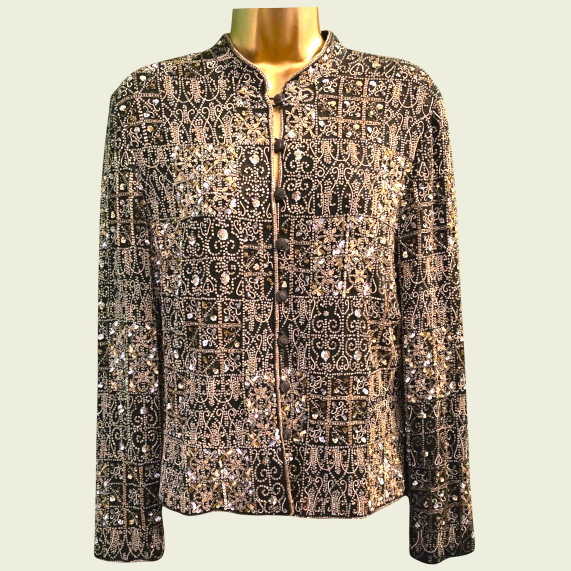 Mannequin wearing a patterned jacket with sequins on a beige background