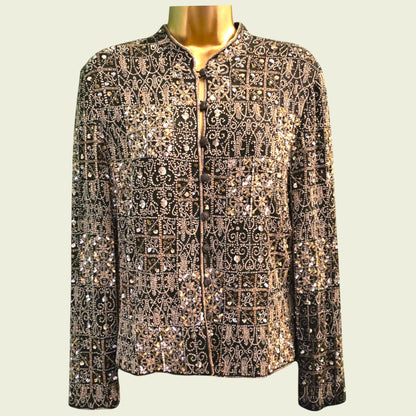 Mannequin wearing a patterned jacket with sequins on a beige background