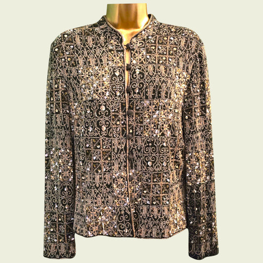 Mannequin wearing a patterned jacket with sequins on a beige background